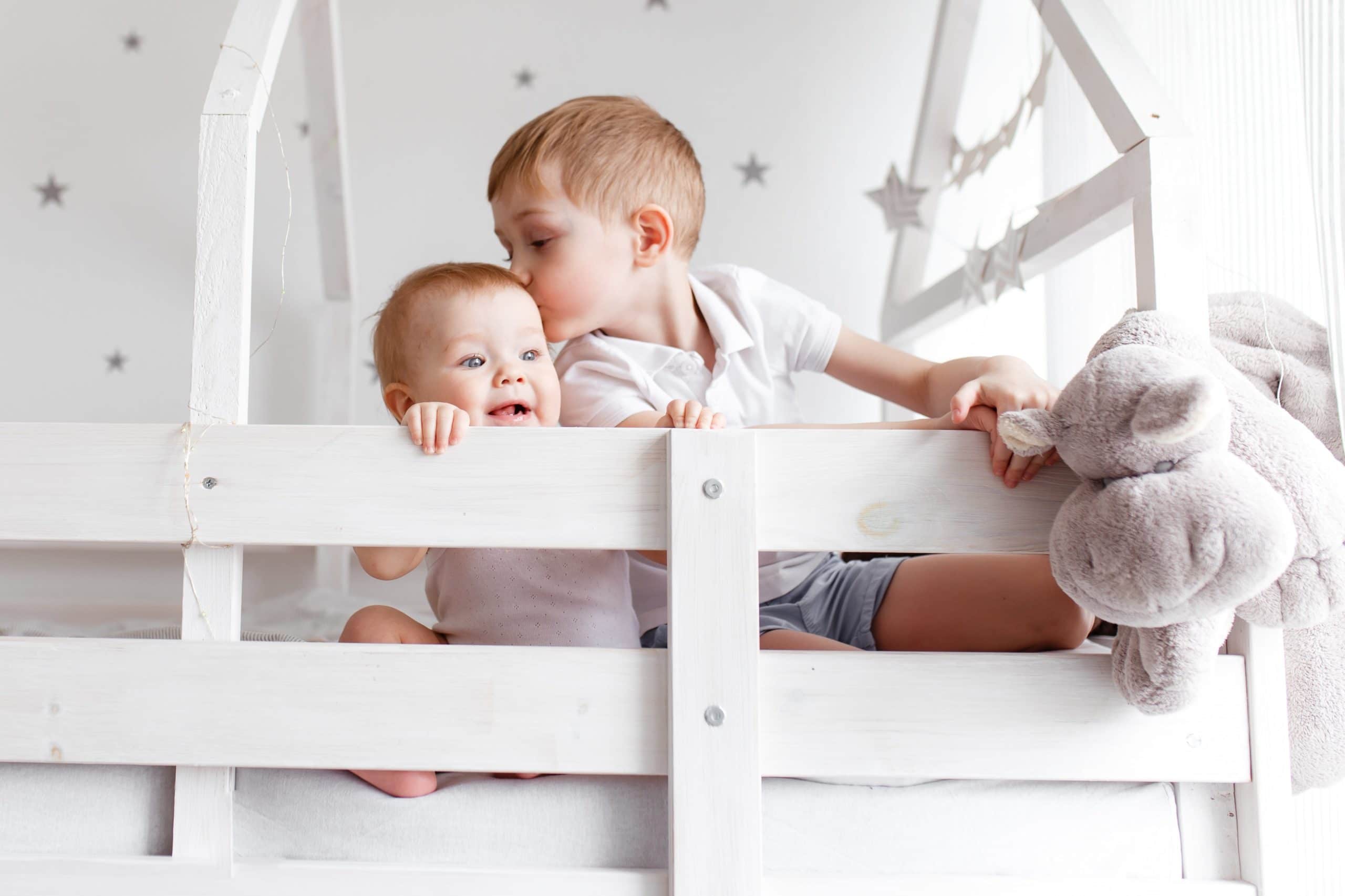 Kinder spielen im Bett im Kinderzimmer zu Hause